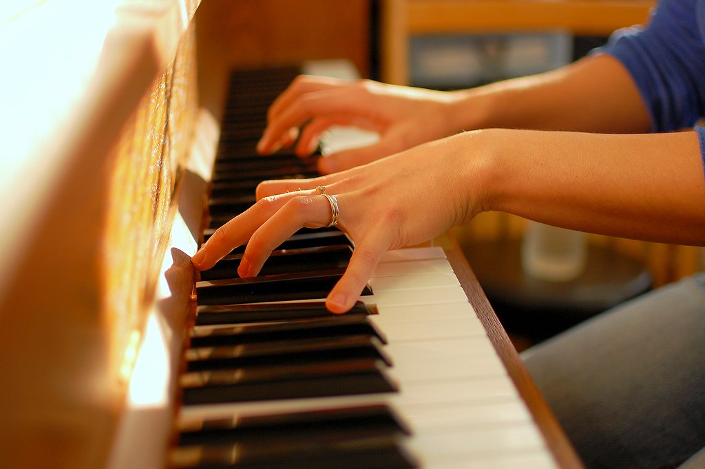 Fingers playing a piano